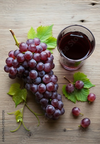 Elegant arrangement of red grapes and juice on weathered wooden surface