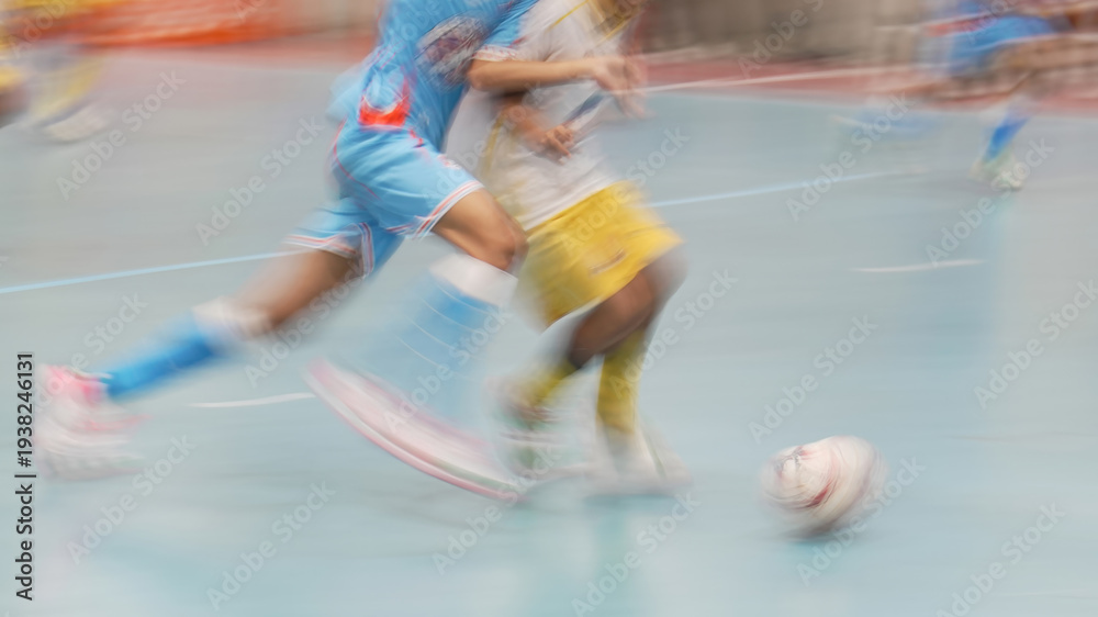 Naklejka premium Dynamic motion blur of futsal players competing for the ball