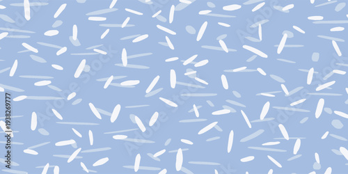 Abstract light blue background with scattered white and light-colored rice grains.