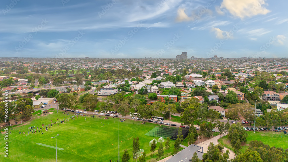 Fototapeta premium Panoramic Aerial Drone view of Inner Suburbs of Melbourne housing, roof tops, the streets and the parks, the roads and trees of Ascot Vale Moonee Ponds Brunswick Essendon and Maribyrnong in VIC Victor