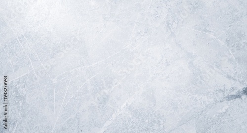 Empty ice rink surface with skate marks and copy space for text or design