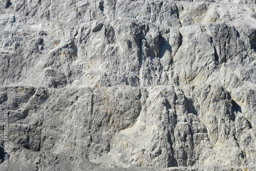 Photos A close up view of a steep stone quarry face showing intricate rocky layers and