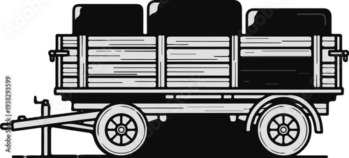 Vintage wooden trailer filled with dark rectangular cargo and two wheels