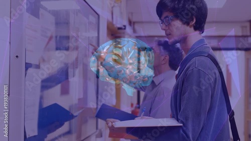 Animation of brain rotating over caucasian male student writing in school