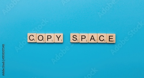 Copy space concept with wooden blocks exhibiting check mark on bright blue panel surface