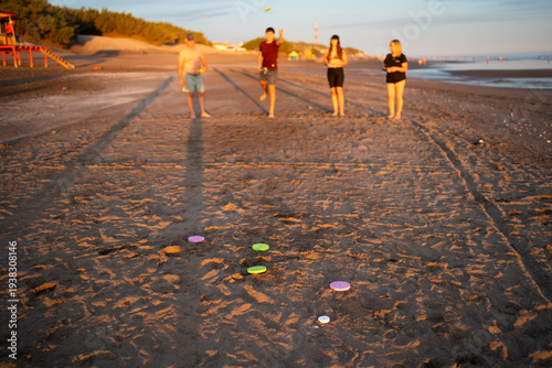 Family playing tejo traditional beach game in argentina