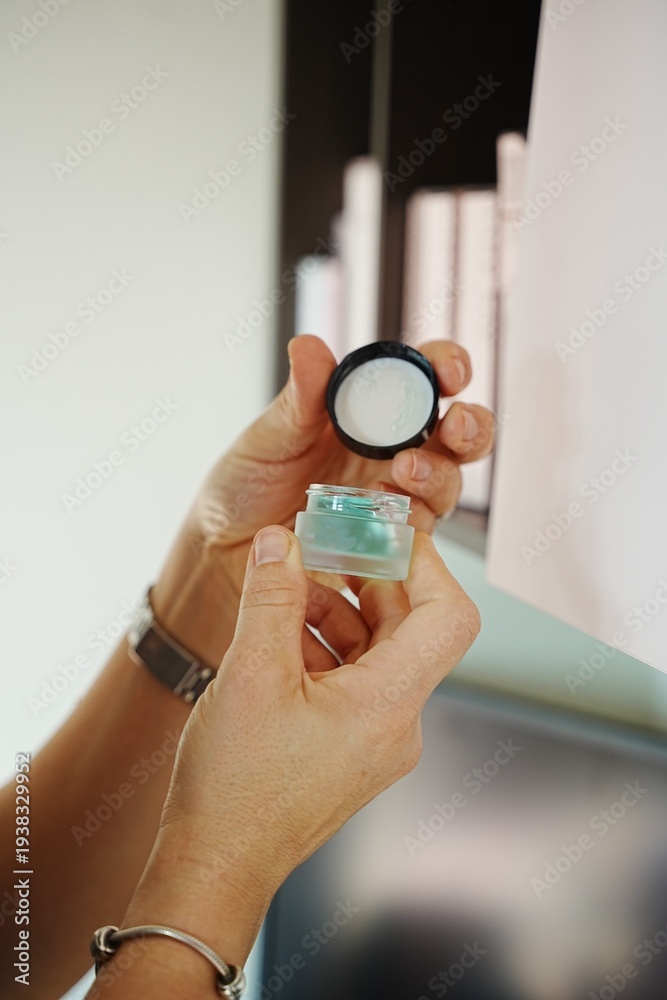 Fototapeta premium Hands Holding Eyeshadow Jar with Lid Opened