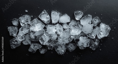 Detailed crushed ice arrangement isolated on a dark black panel with subtle highlights