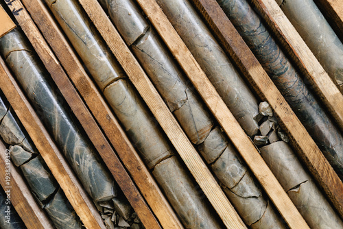 Konstfotografi Geological rock core samples and wooden slabs arranged in diagonal, top view