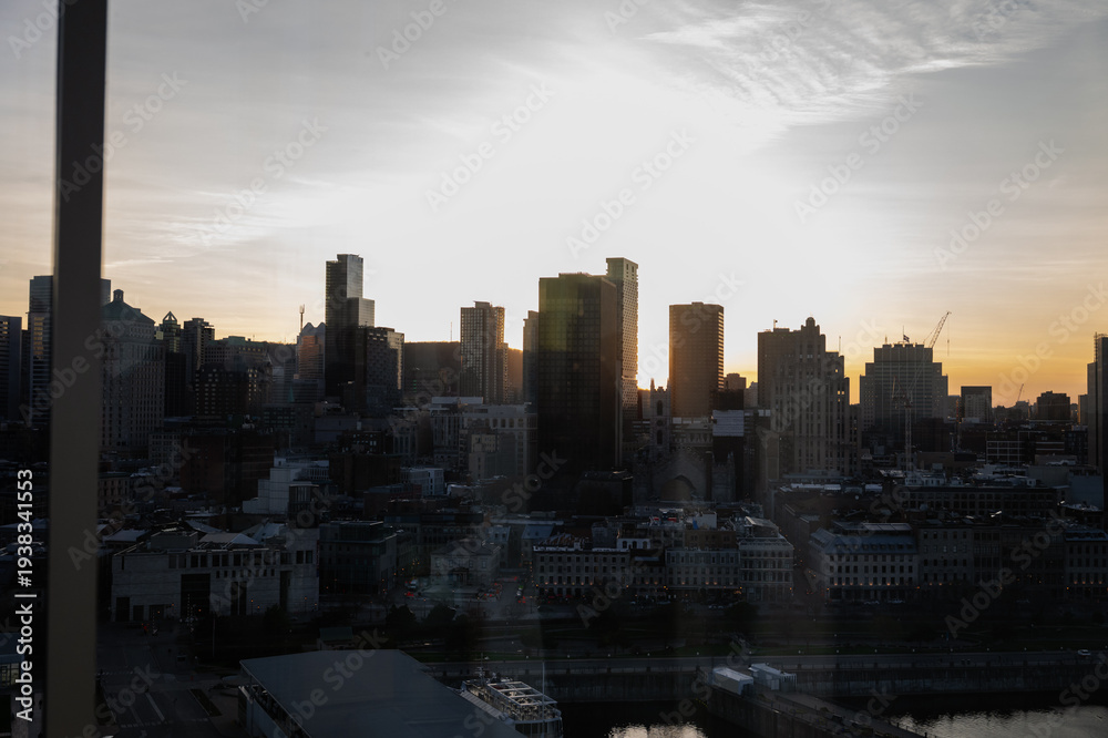 Fototapeta premium The city skyline is juxtaposed against a vibrant sunset, the buildings catching the warm colors of the sky, symbolizing urban growth and the beauty of daily transitions.