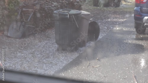ice falling from trees coated in freezing rain in the backyard  in February with sound