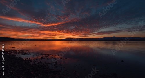 Calm lakeshore sunset with ...