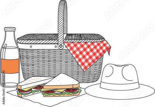 Wicker picnic basket setup with sandwiches a drink and sun hat ready for outing