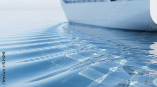 Detailed view of sparkling blue ocean water ripples with a cargo ship cruising in the distance.