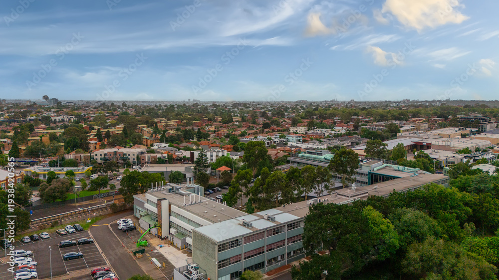 Fototapeta premium Panoramic Aerial Drone view of Inner Suburbs of Melbourne housing, roof tops, the streets and the parks, the roads and trees of Ascot Vale Moonee Ponds Brunswick Essendon and Maribyrnong in VIC Victor