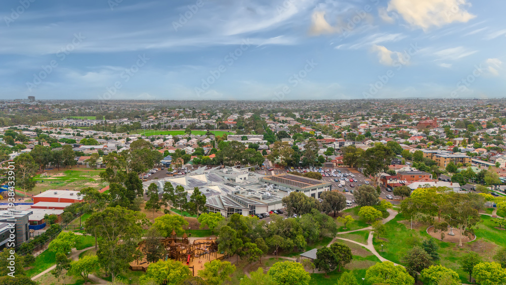 Fototapeta premium Panoramic Aerial Drone view of Inner Suburbs of Melbourne housing, roof tops, the streets and the parks, the roads and trees of Ascot Vale Moonee Ponds Brunswick Essendon and Maribyrnong in VIC Victor