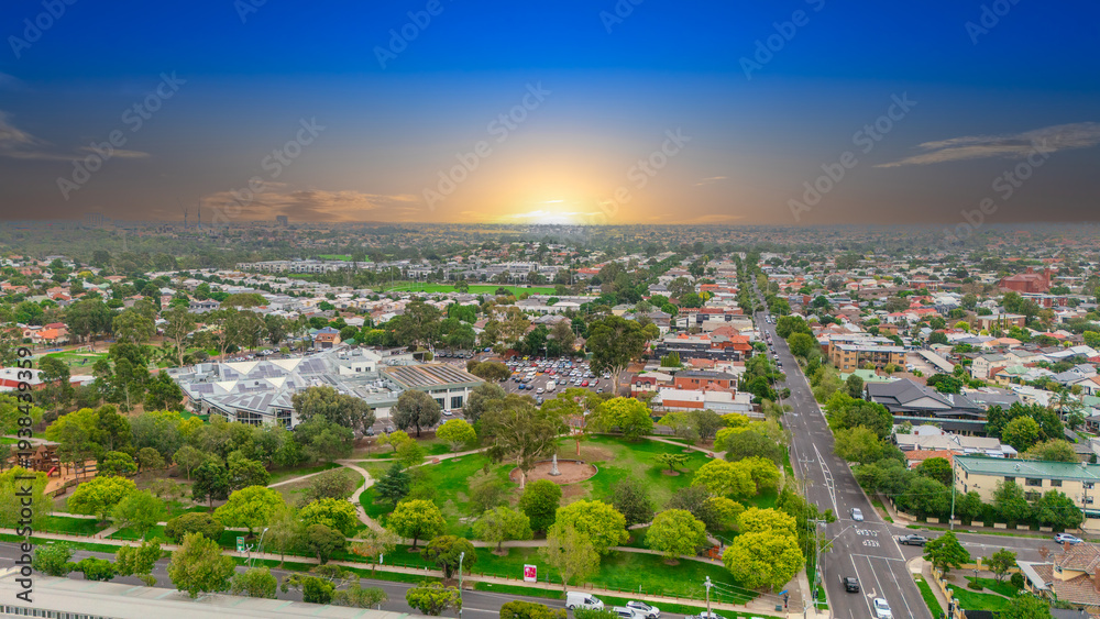 Fototapeta premium Panoramic Aerial Drone view of Inner Suburbs of Melbourne housing, roof tops, the streets and the parks, the roads and trees of Ascot Vale Moonee Ponds Brunswick Essendon and Maribyrnong in VIC Victor