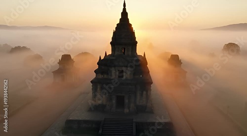 Stunning aerial view of a temple complex shrouded in thick morning fog