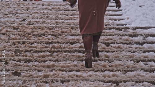 Anonymous Pedestrian People Walking Up and Down Slippery Overpass Stairs Covered in Snow Slush Mud