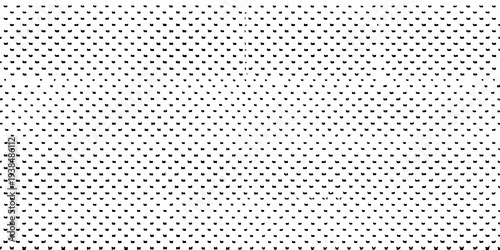 A dense repeating pattern of small dark geometric shapes on white