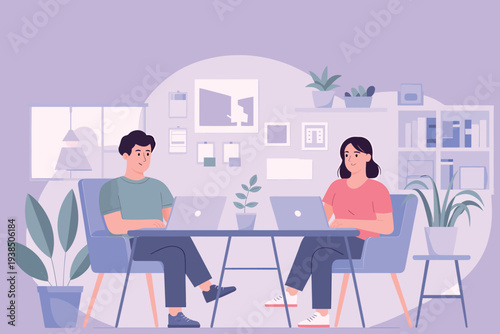 Two people working on laptops in a modern plant filled office space