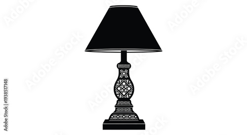 A black table lamp with a patterned base and lampshade isolated on a white background