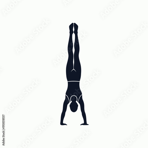 Woman performing a handstand in a yoga pose.