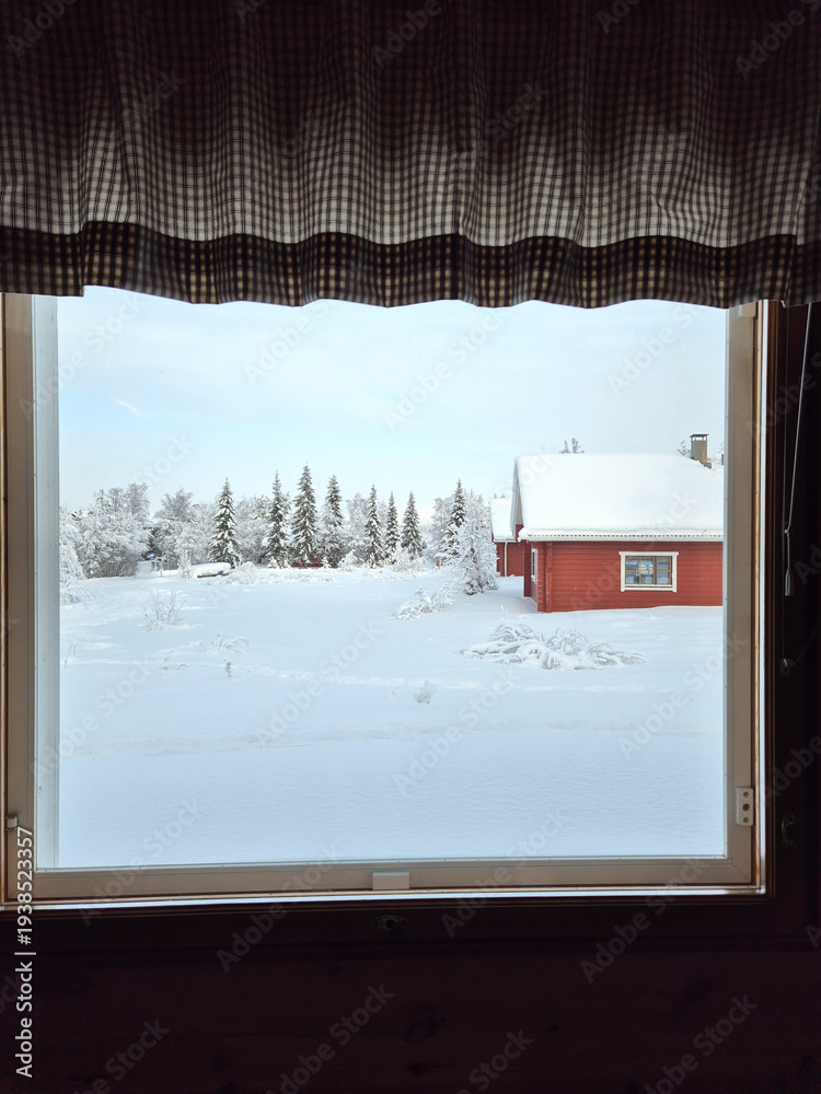 Fototapeta premium Winter wonderland view from a cozy cabin in Akaslompolo, Lapland, Finland