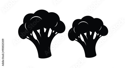 Two broccoli florets depicted in a stark black silhouette