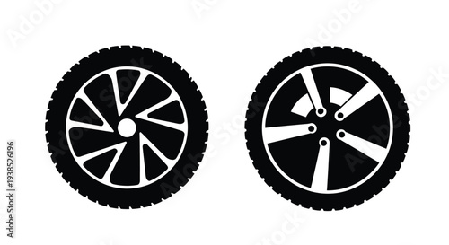 Two black car wheels with detailed treads in a stark silhouette