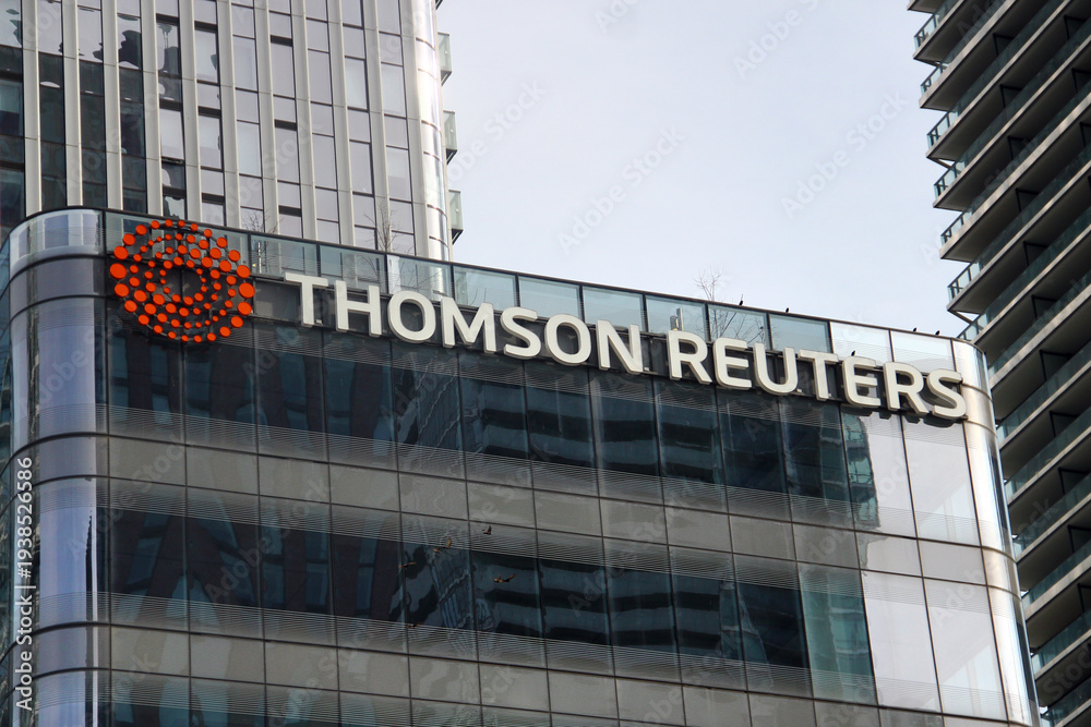 Naklejka premium Toronto, Canada - February 15, 2026: Thomson Reuters office building facade with logo in downtown Toronto financial district surrounded by modern glass skyscrapers