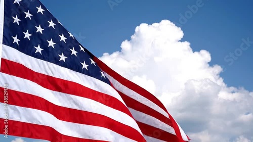 Vibrant United States flag proudly waving against a clear blue sky, symbolizing freedom, patriotism, and national pride