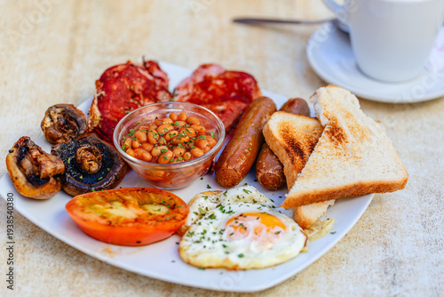 Traditional breakfast platter served with eggs, sausage, and beans