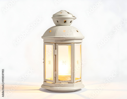 White lantern with glowing candle, casting warm light on white background