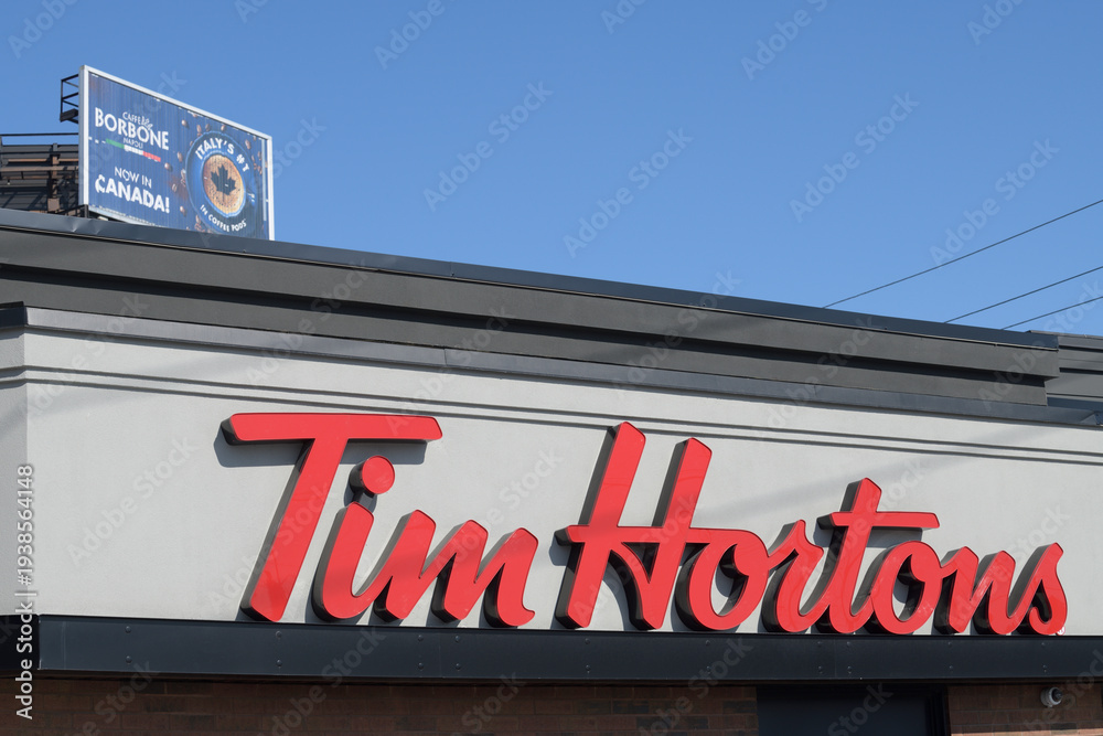 Naklejka premium sign on the outside of Tim Hortons, a coffee shop, located at 1900 O'Connor Dr, North York, Toronto
