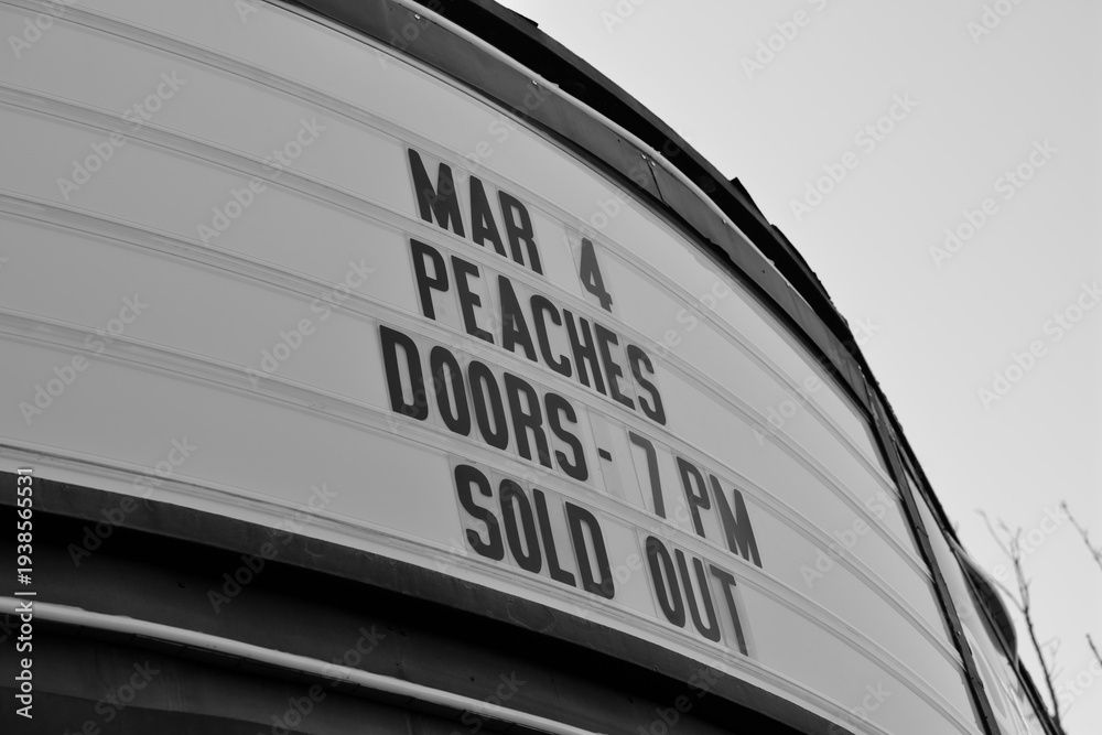 Fototapeta premium black and white view of a marquee sign outside Danforth Music Hall for sold out event held March 4 2026, 147 Danforth Av, Toronto