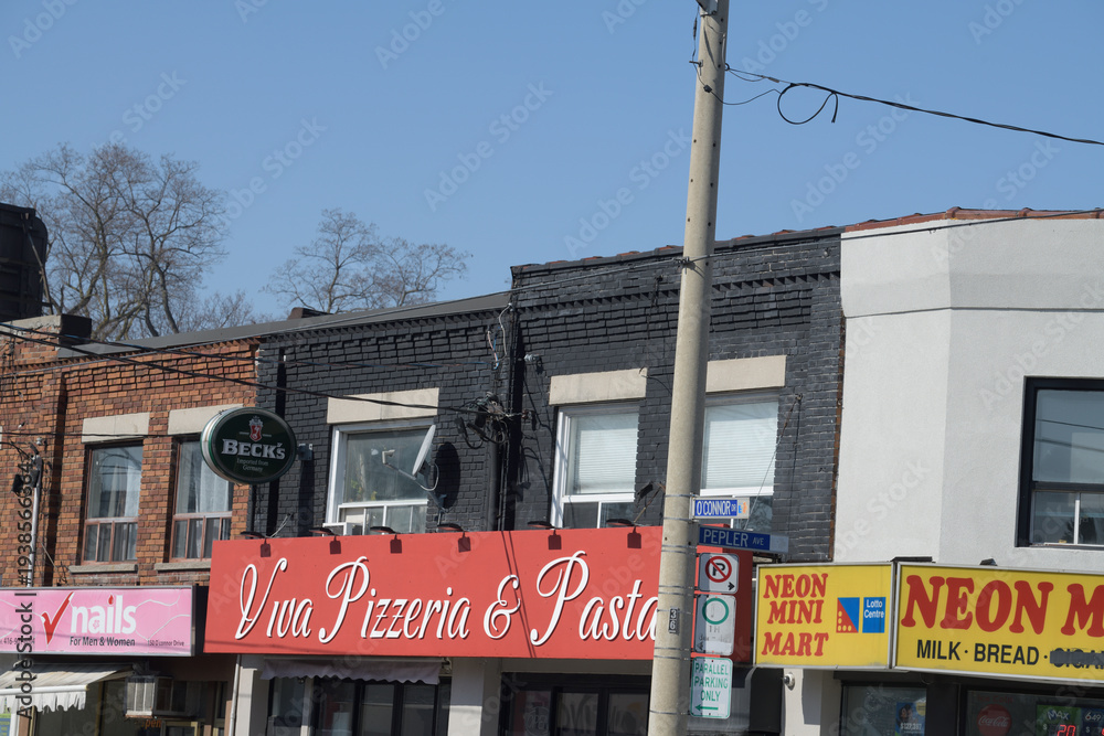Obraz premium exterior of shops on O'Connor Dr including Viva Pizzeria & Pasta House, a restaurant, located at 158 O'Connor Dr, Toronto