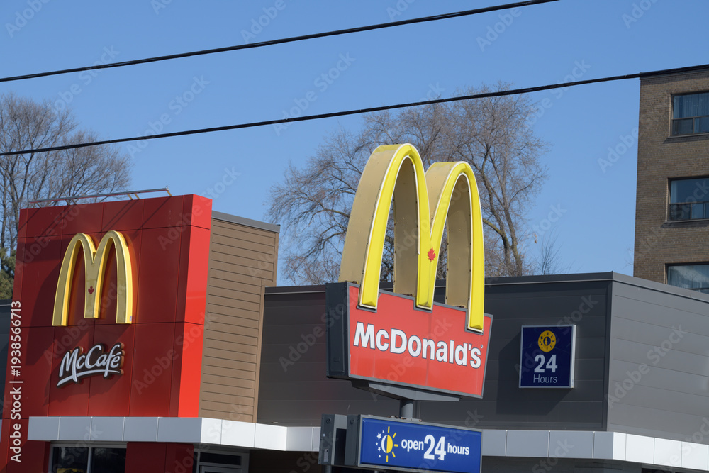 Fototapeta premium iconic Golden Arches sign outside a location of McDonald's Canada fast food restaurant at 1045 Pape Av, Toronto