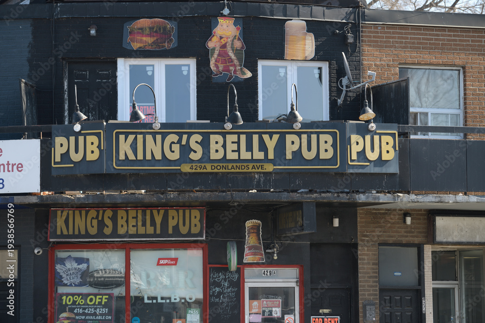 Fototapeta premium exterior building facade and sign of King's Belly Pub located at 429a Donlands Av, East York, Toronto