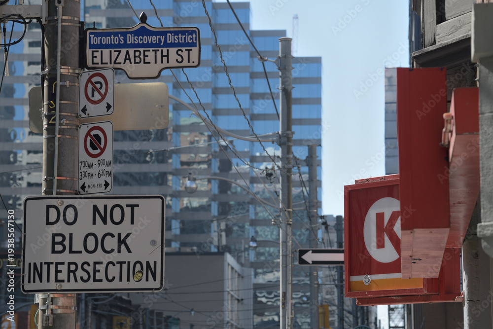 Obraz premium looking west on Dundas St W to street and shop signs incl Circle K, a convenience store chain, located here at 144 Dundas St W, Toronto