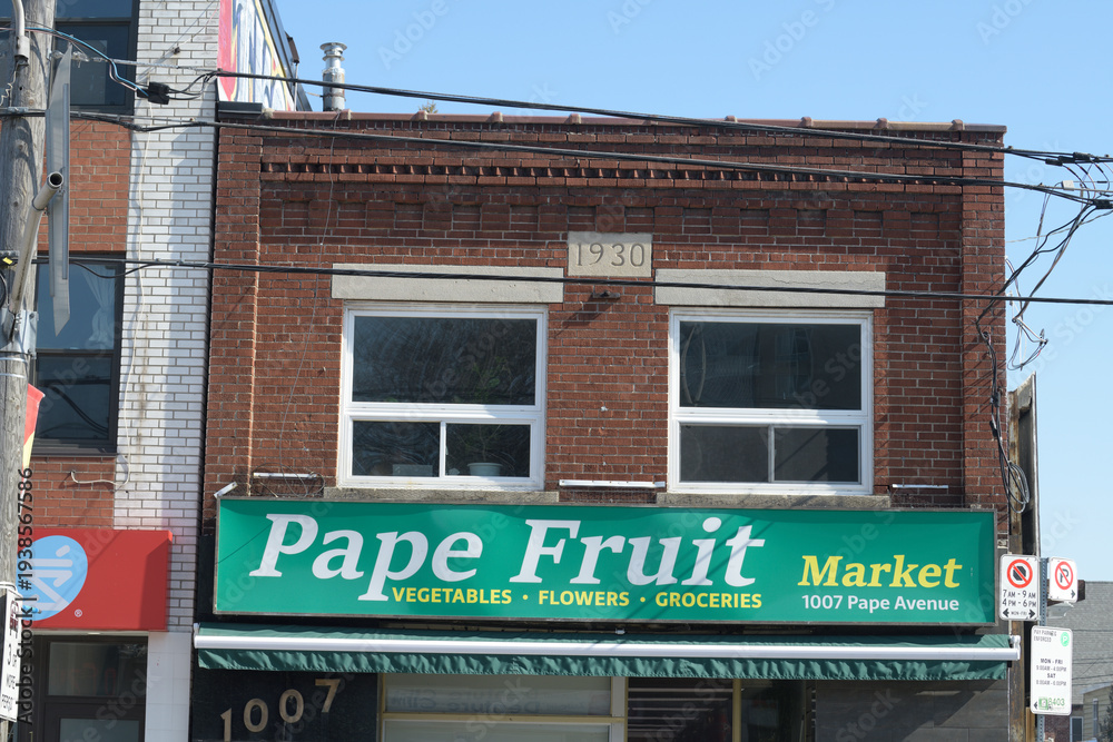 Fototapeta premium exterior building facade and sign of Pape Fruit Market at 1007 Pape Av, East York, Toronto