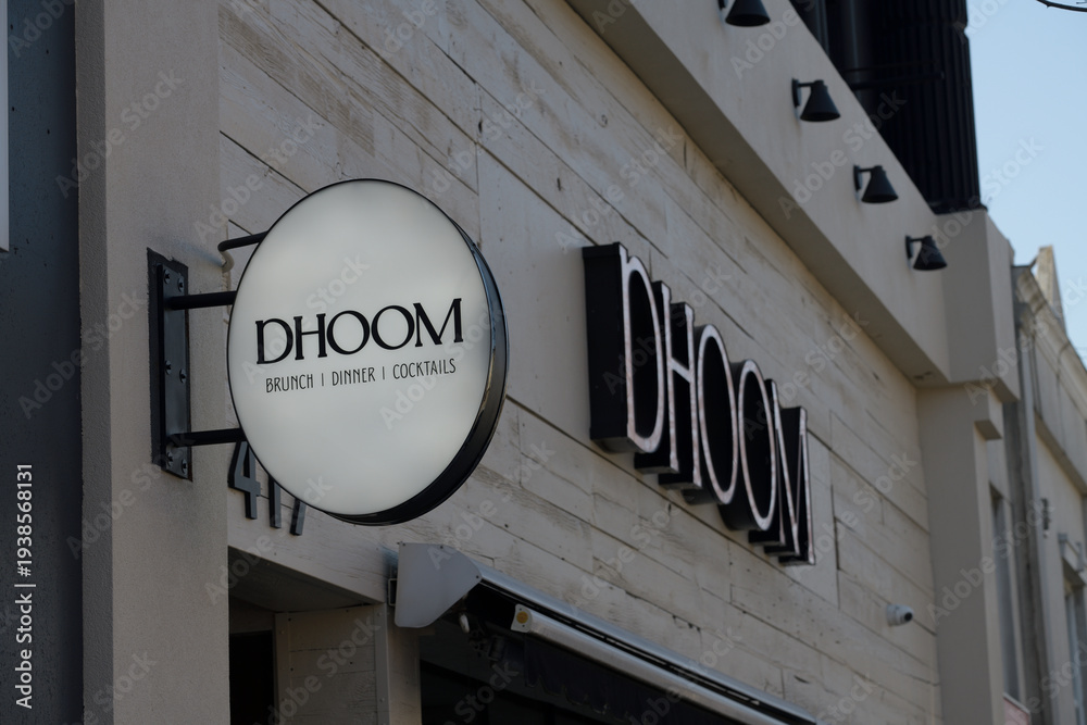 Obraz premium wall mounted projecting sign outside DHOOM Modern Indian Bar & Kitchen, an Indian restaurant, located at 417 Danforth Av, Toronto