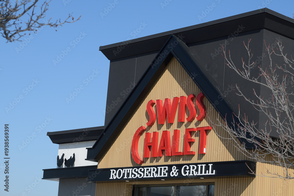 Fototapeta premium exterior building facade and sign of Swiss Chalet, a restaurant chain, located here at 1400 O'Connor Dr, East York, Toronto