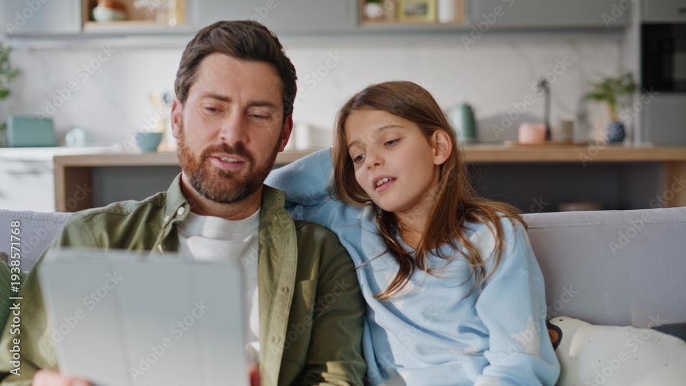 Obraz premium Dad daughter shopping online using tablet home closeup. Smiling father girl