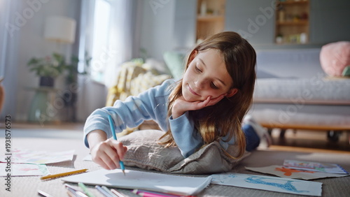 Dreamy girl drawing home floor closeup. Relaxed preteen child creating picture