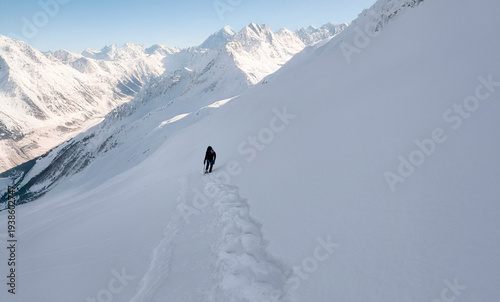 A lone mountaineer's winter fairytale hike against a backdrop of stunning, unique mountain scenery.