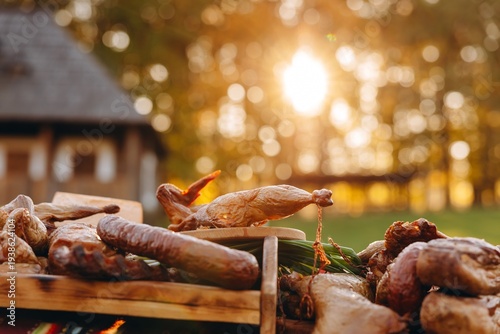 Smoked meats and sausages on a rustic wooden table at golden hour outdoor feast