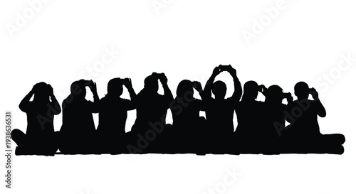 A crowd of people with raised arms captured in black silhouette