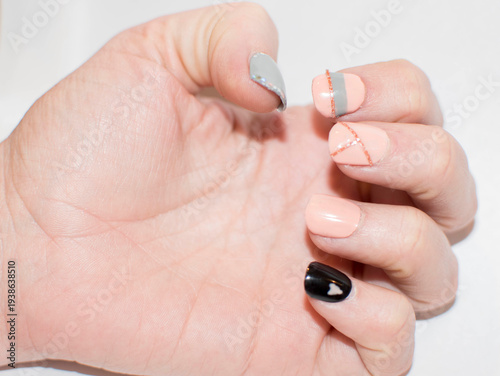 Hand with Nude and Black Nails Featuring Minimalist Art
