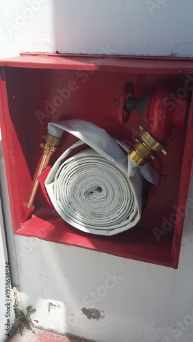 Fire Safety Equipment Red Cabinet With Rolled White Hose